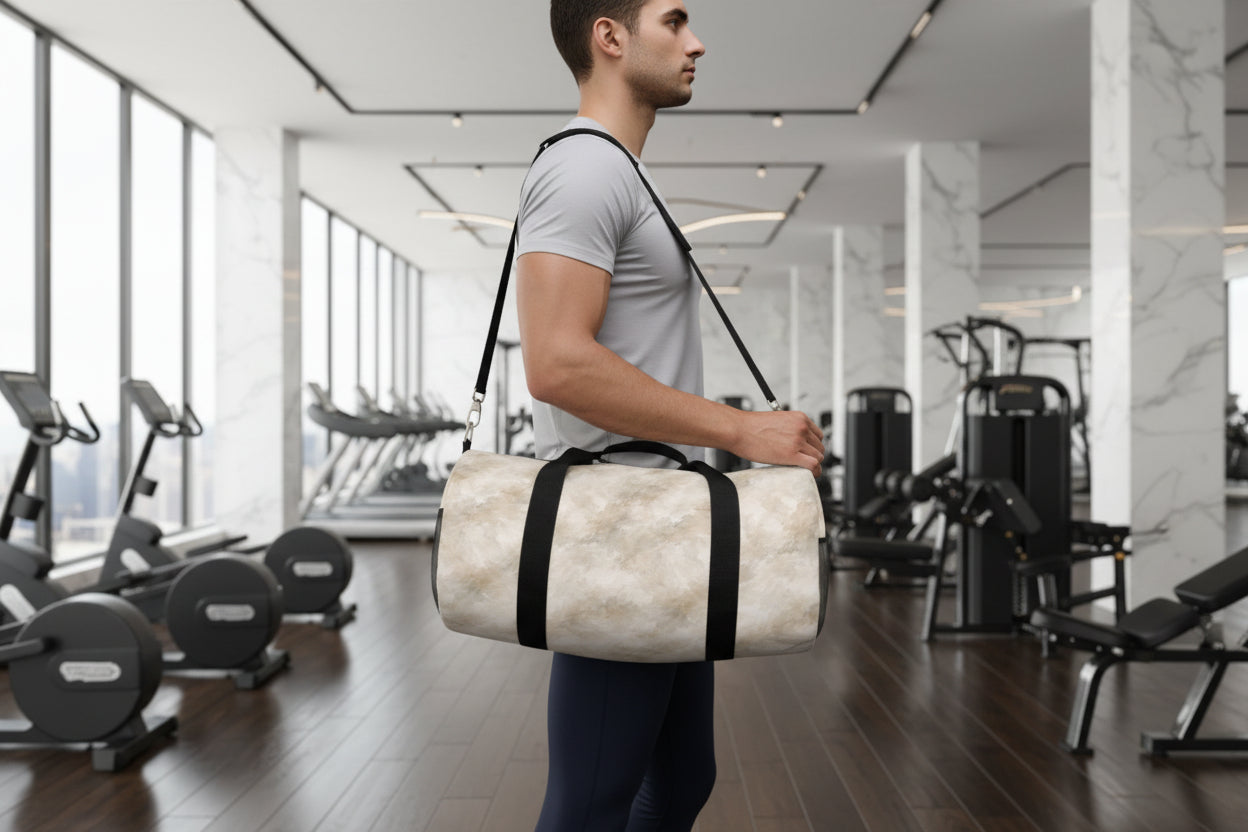 Person holding a marble-textured duffel bag with black straps on a plain background