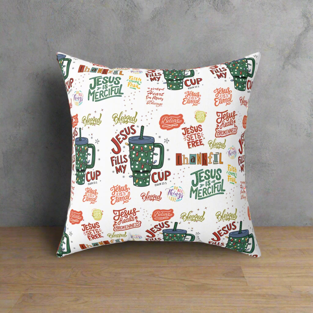 Decorative pillow with religious text and mugs design on a white background