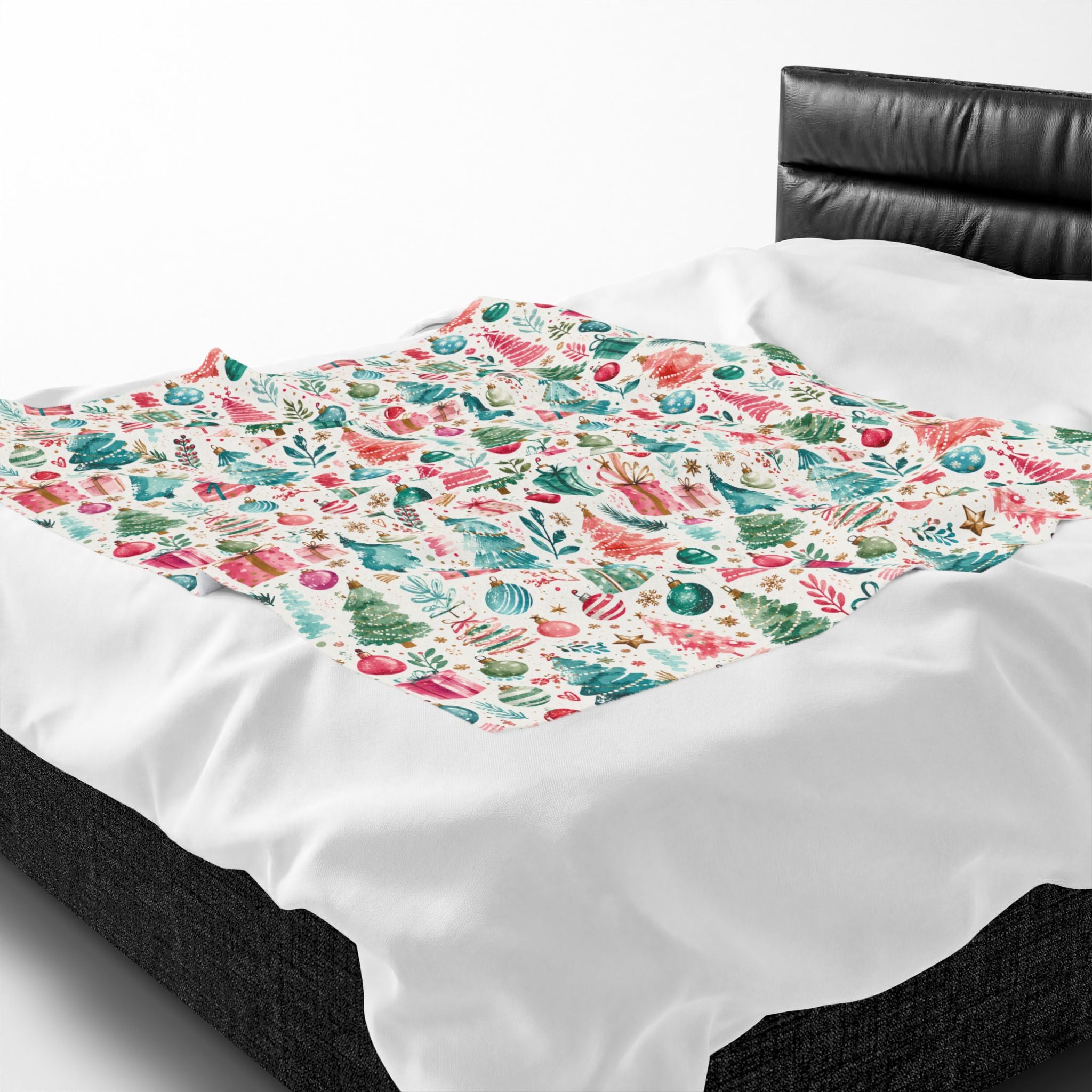 A white throw blanket featuring a colorful underwater seashell and coral print, draped over a bed with a black leather headboard.
