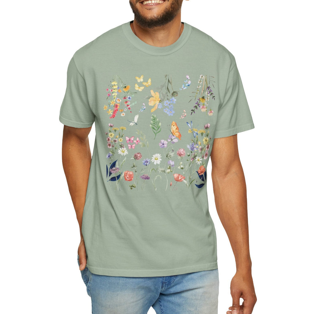 Man wearing a light green t-shirt with floral and butterfly design on a white background