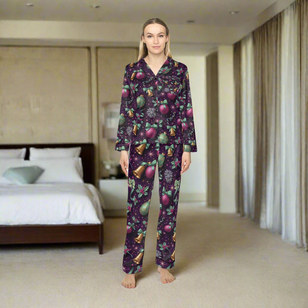 Woman wearing a festive pajama set with purple and green pattern on a white background