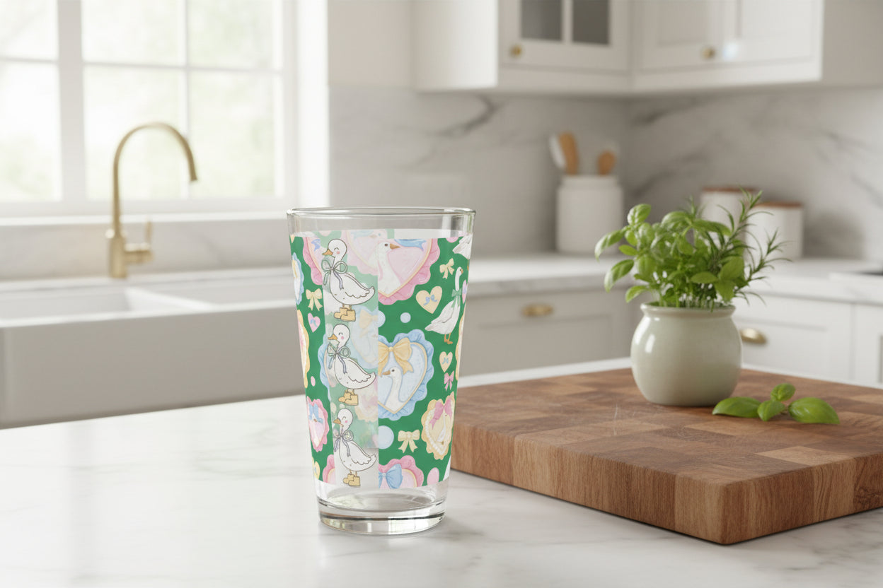 Glass tumbler with a colorful bird pattern on a green background