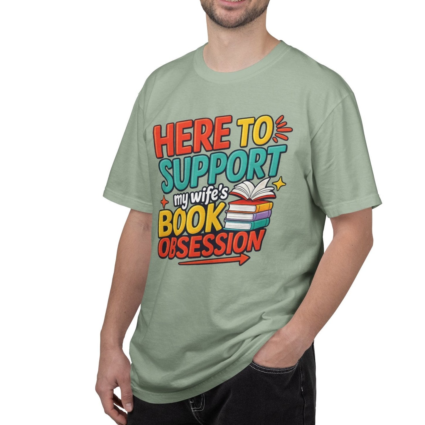 Man wearing a light green t-shirt with colorful text on a white background