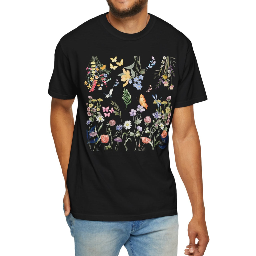 Man wearing a black t-shirt with a colorful floral and butterfly design on a white background