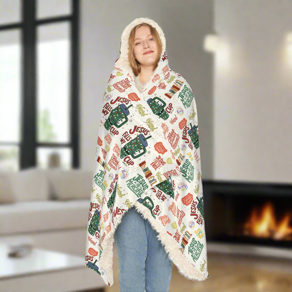 Person wearing a colorful blanket with text and graphics on a white background