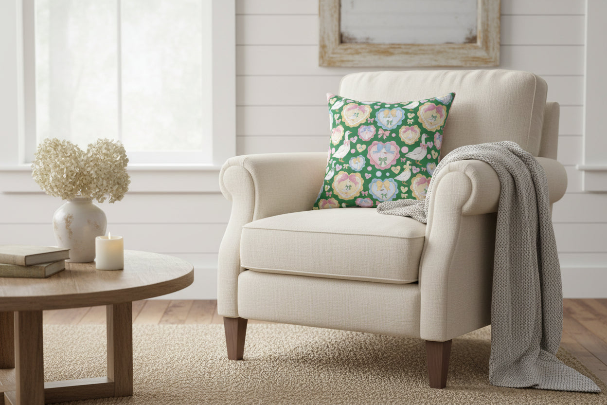 Decorative pillow with a pattern of ducks, hearts, and flowers on a green background