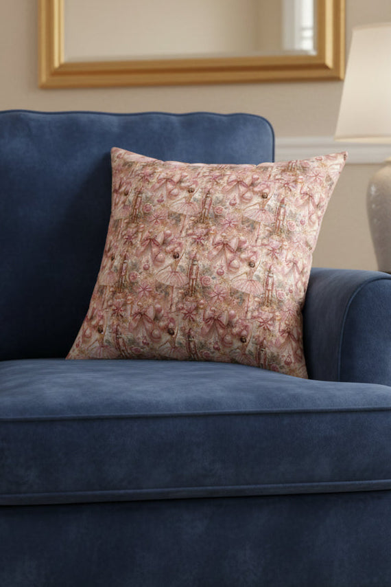 Decorative pillow with pink and gold pattern on a white background
