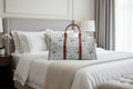 Floral-patterned duffel bag on a bed in a bedroom setting