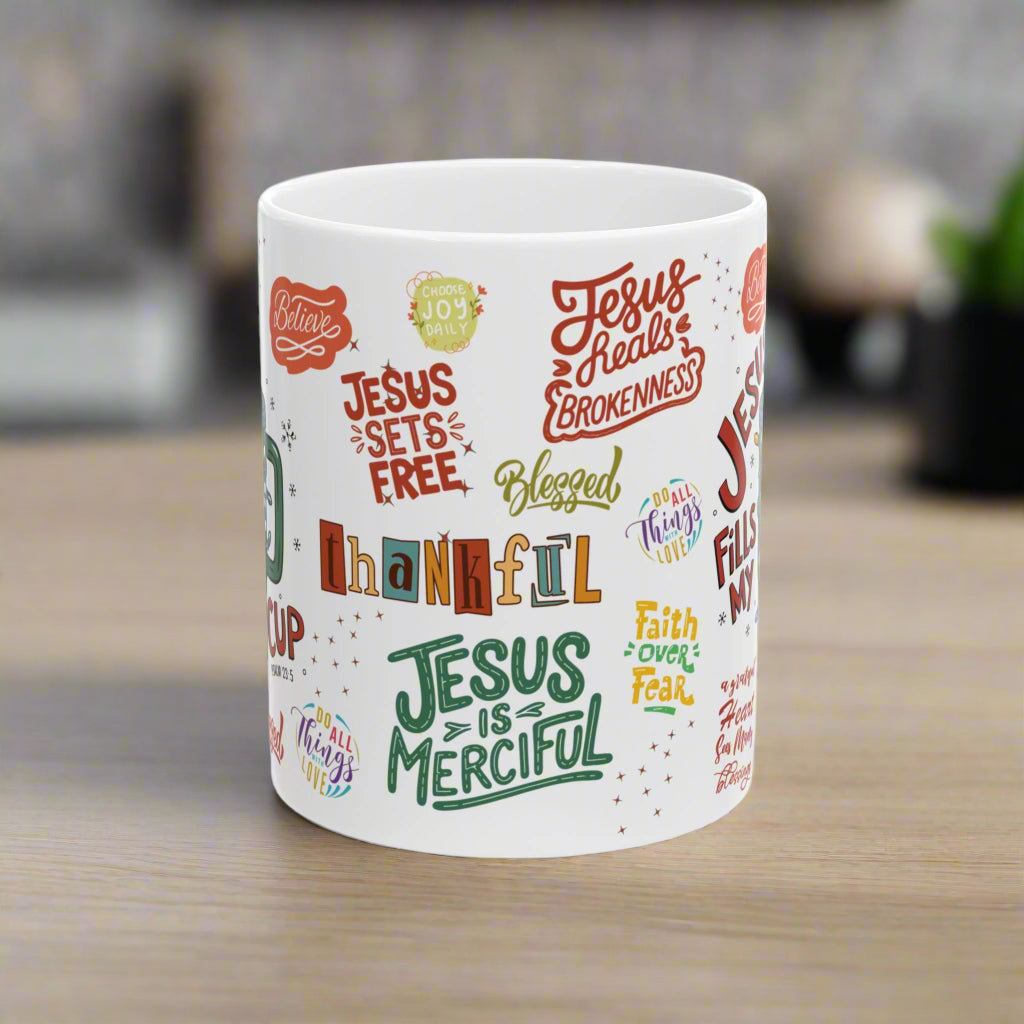White mug with colorful text designs on a white background