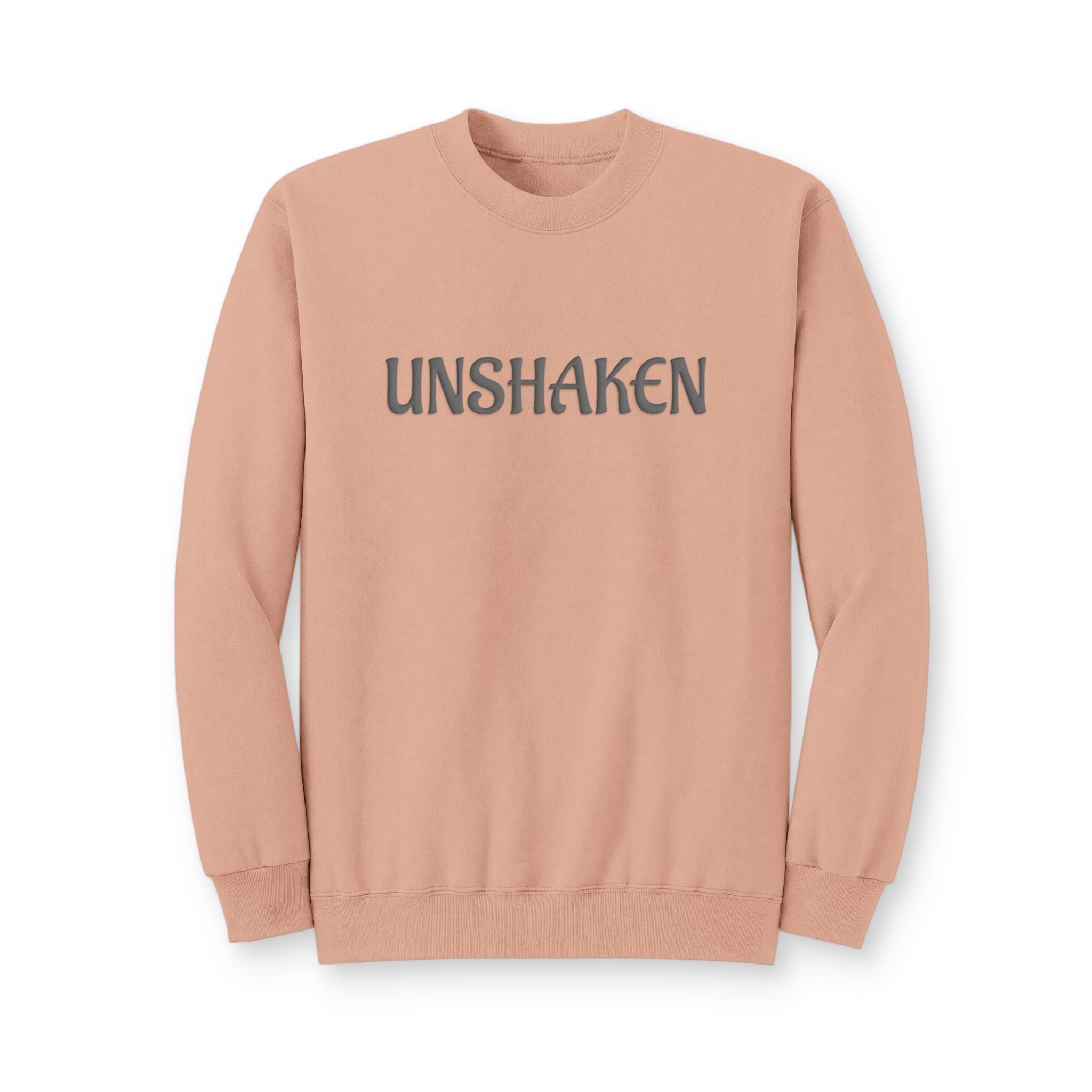 A dusty rose crewneck sweatshirt with the word 'UNSHAKEN' printed across the chest in a dark gray serif font, displayed on a clean white background.