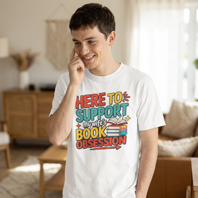 Man wearing a white t-shirt with colorful text in a living room.