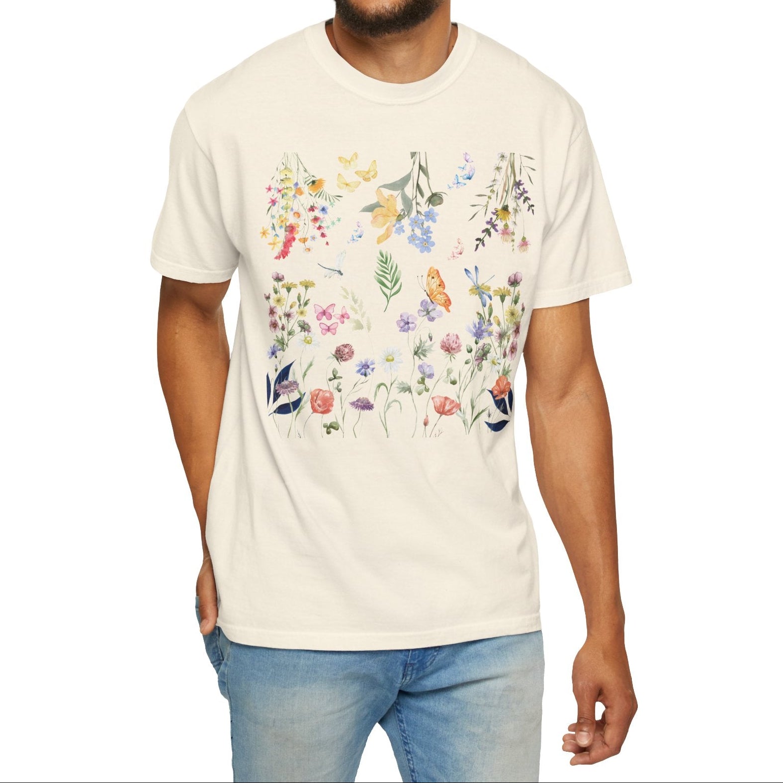 Man wearing a cream t-shirt with floral designs on a white background