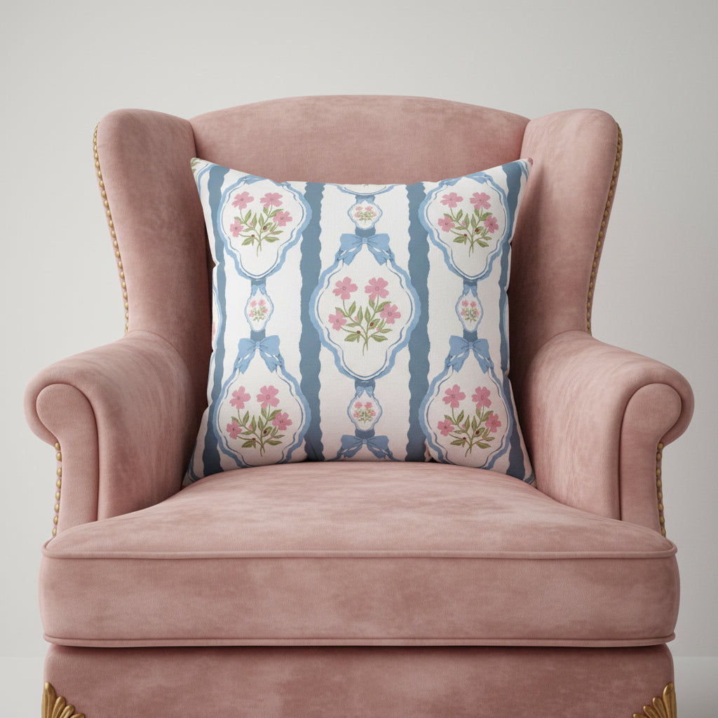 Decorative pillow with floral and bow pattern on a white background