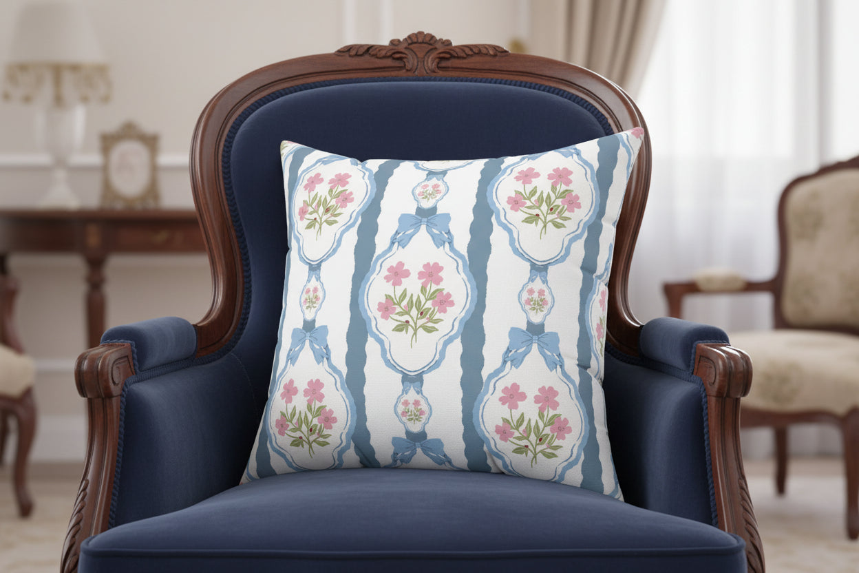 Decorative pillow with floral and bow pattern on a white background