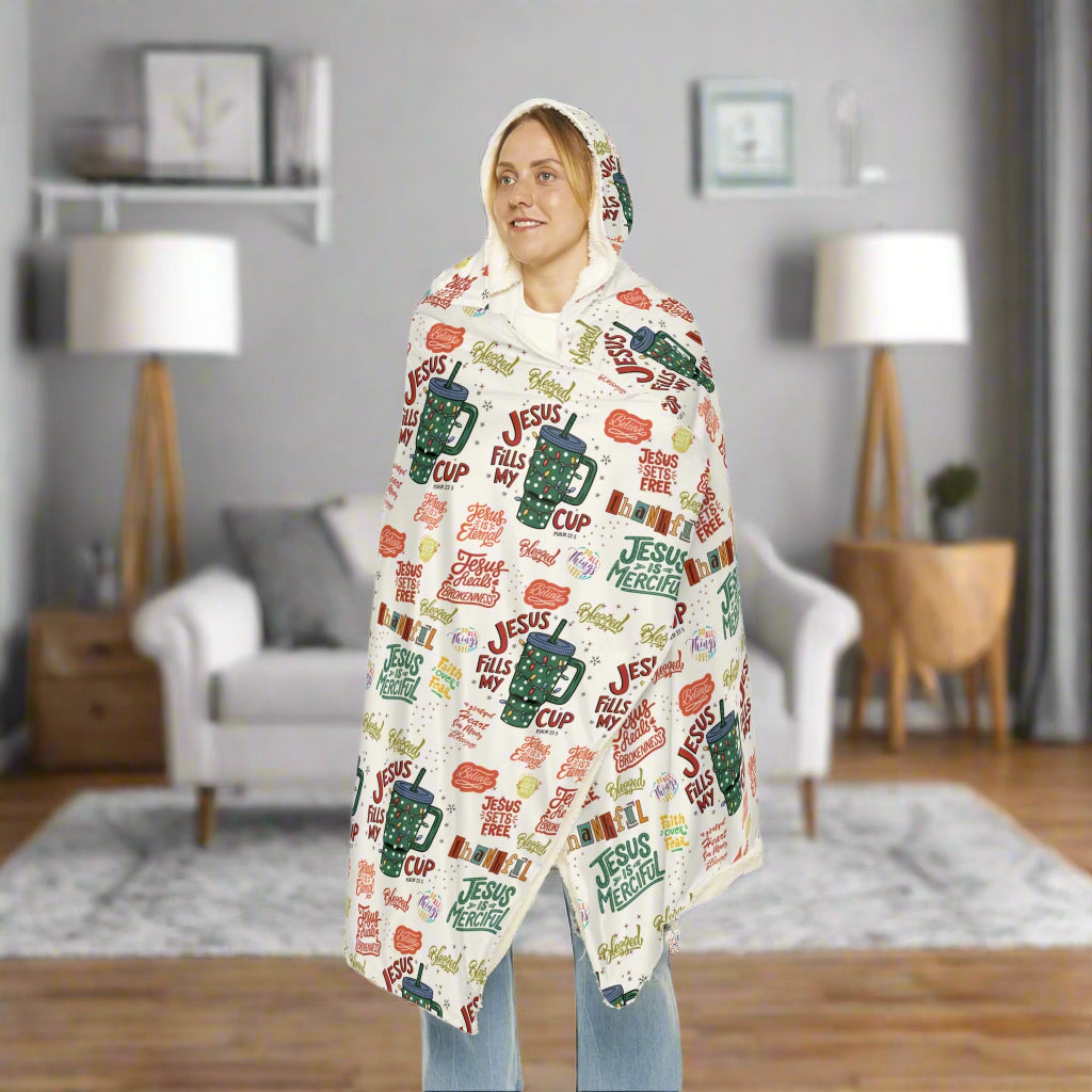 Person wrapped in a colorful blanket with text and graphics on a white background