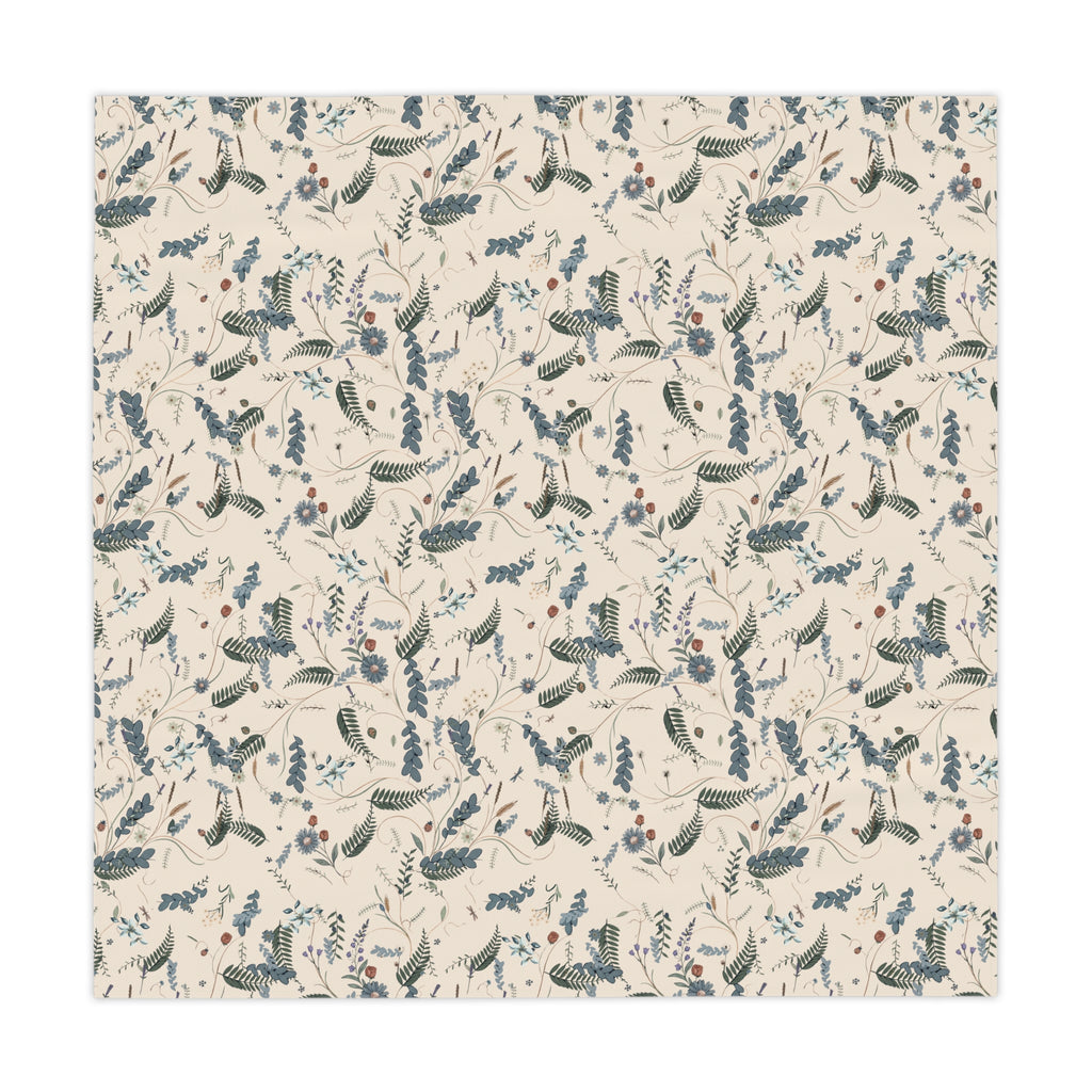 Patterned fabric with blue and black designs on a beige background