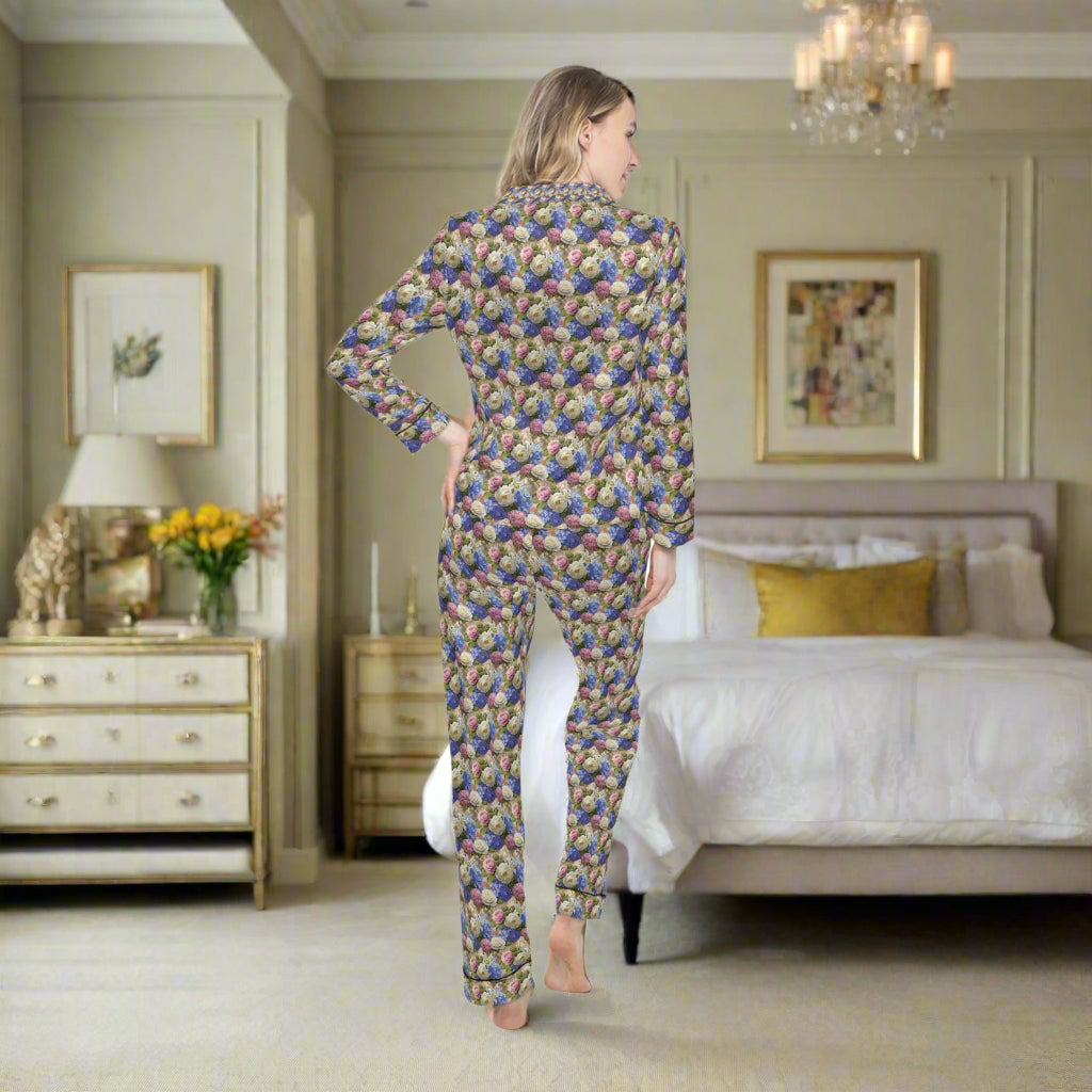 Woman wearing a colorful patterned pajama set on a white background