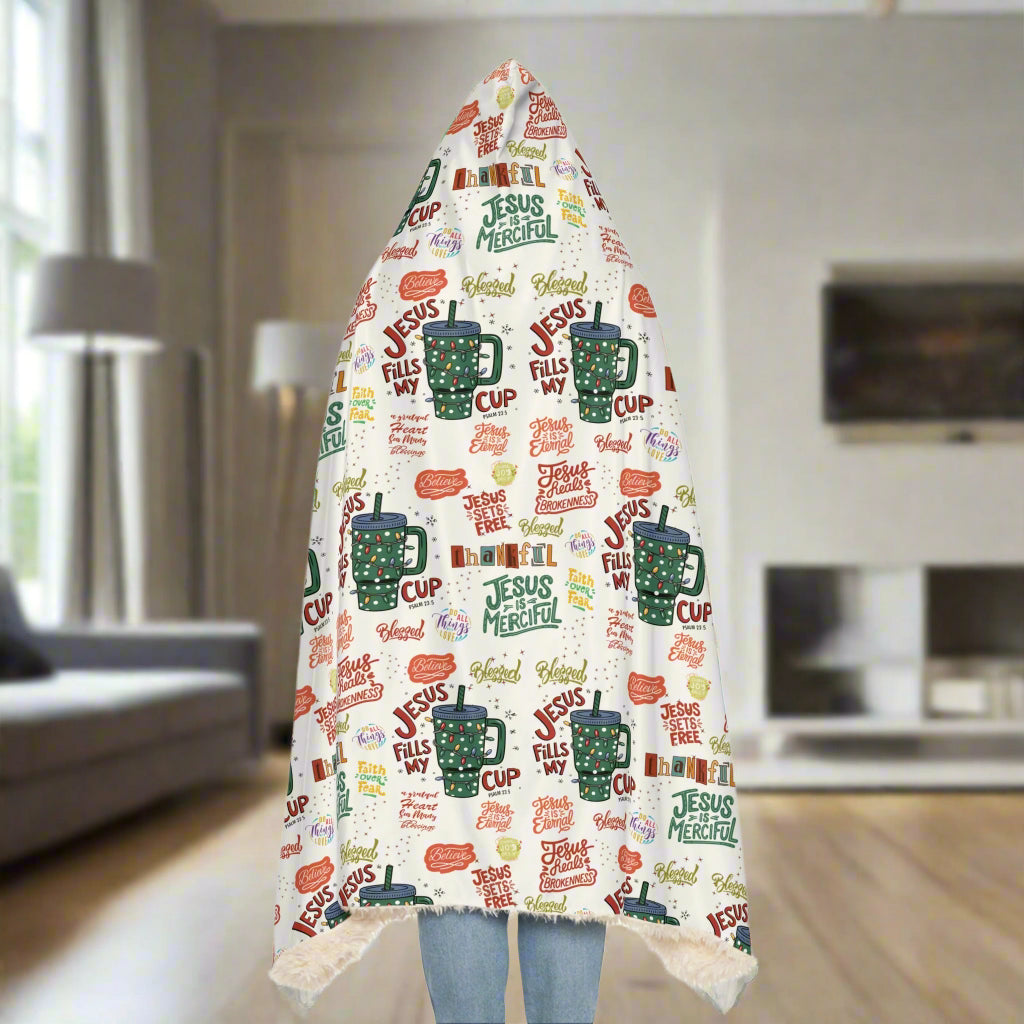Blanket with 'Jesus Fills My Cup' text and mugs pattern on a white background