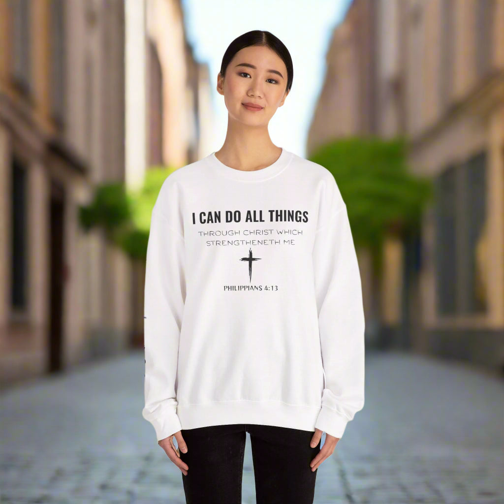 Person wearing a white sweatshirt with a motivational quote and cross design on a white background