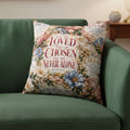 A square decorative throw pillow featuring a vintage-style floral print with religious text from Isaiah 45:10. The design includes soft pink, blue, and beige flowers on a cream background with red and dark brown typography reading 'YOU ARE LOVED YOU ARE CHOSEN YOU ARE NEVER ALONE'.