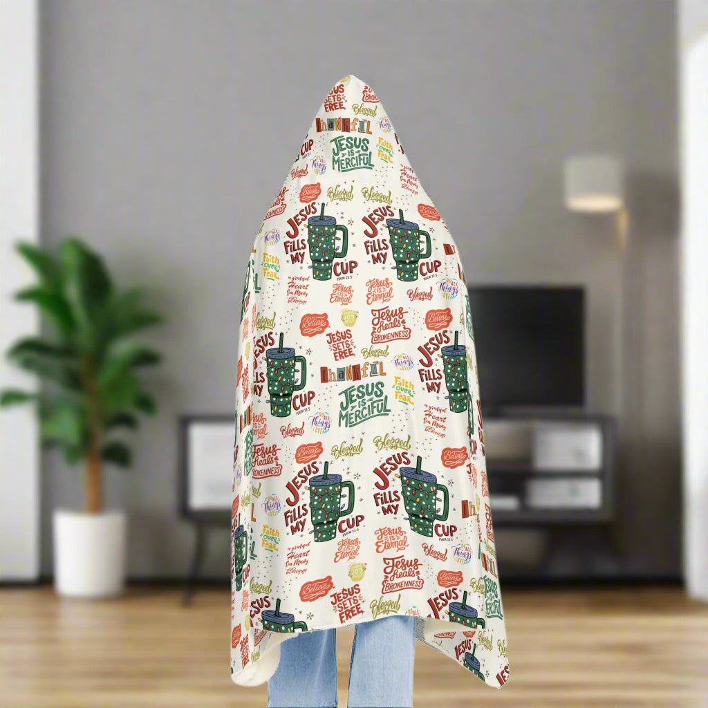 Hooded blanket with colorful text and mugs design on a white background