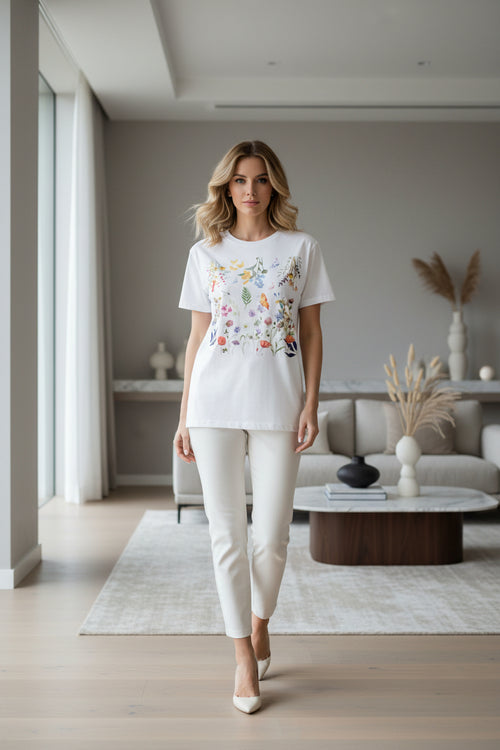 White t-shirt with colorful floral design on a white background