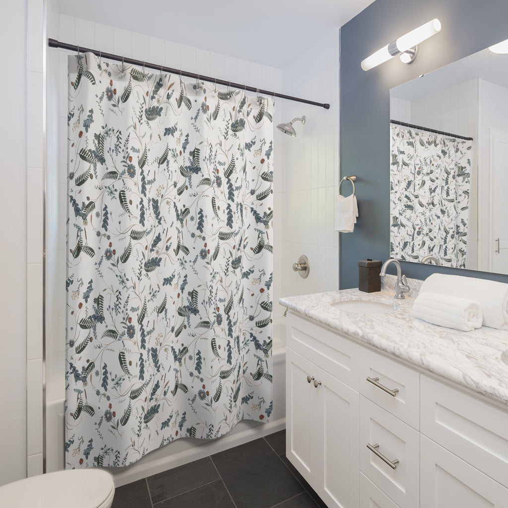 Bathroom with a floral-patterned shower curtain, sink, and mirror.