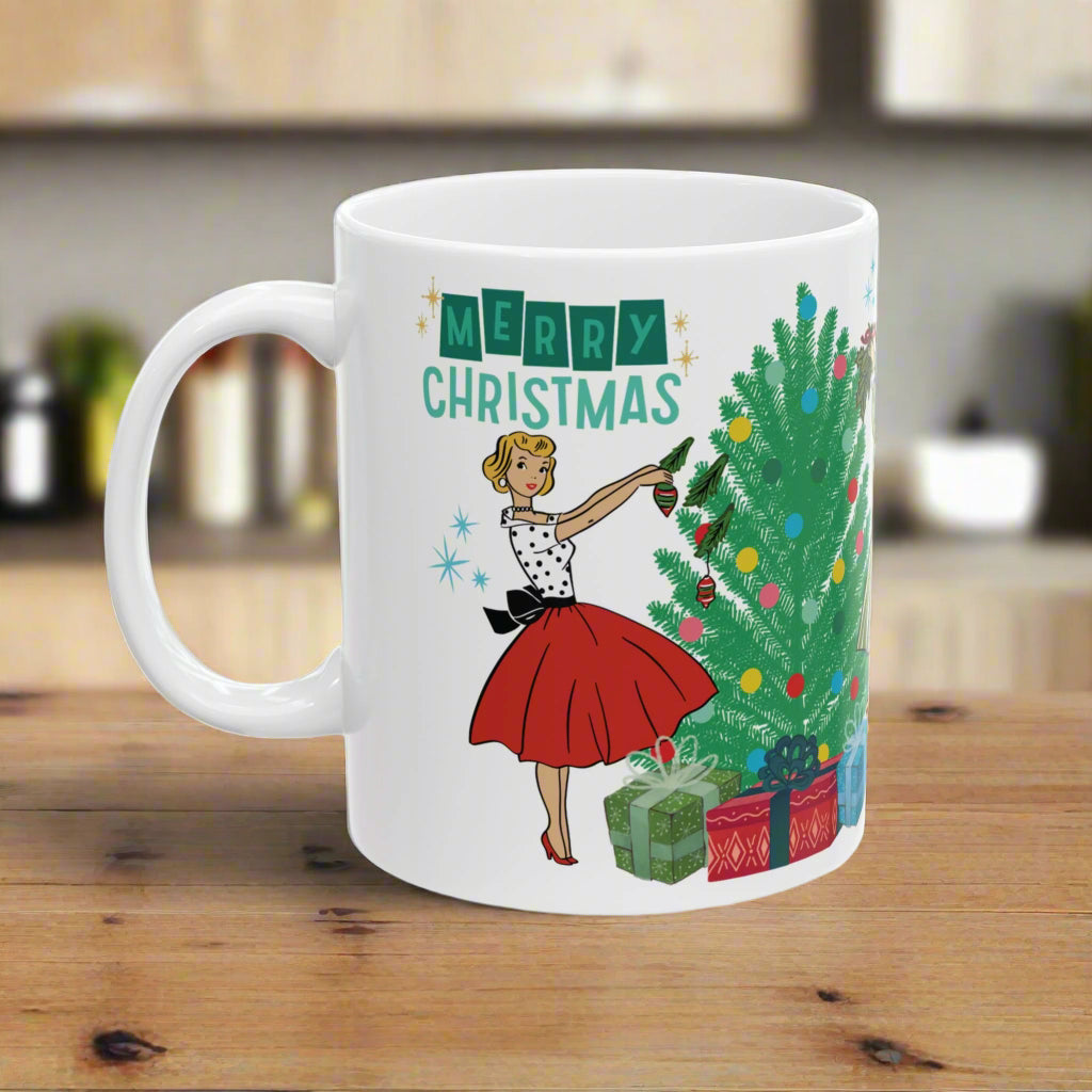 White mug with a Christmas design featuring a woman decorating a tree and 'Merry Christmas' text.
