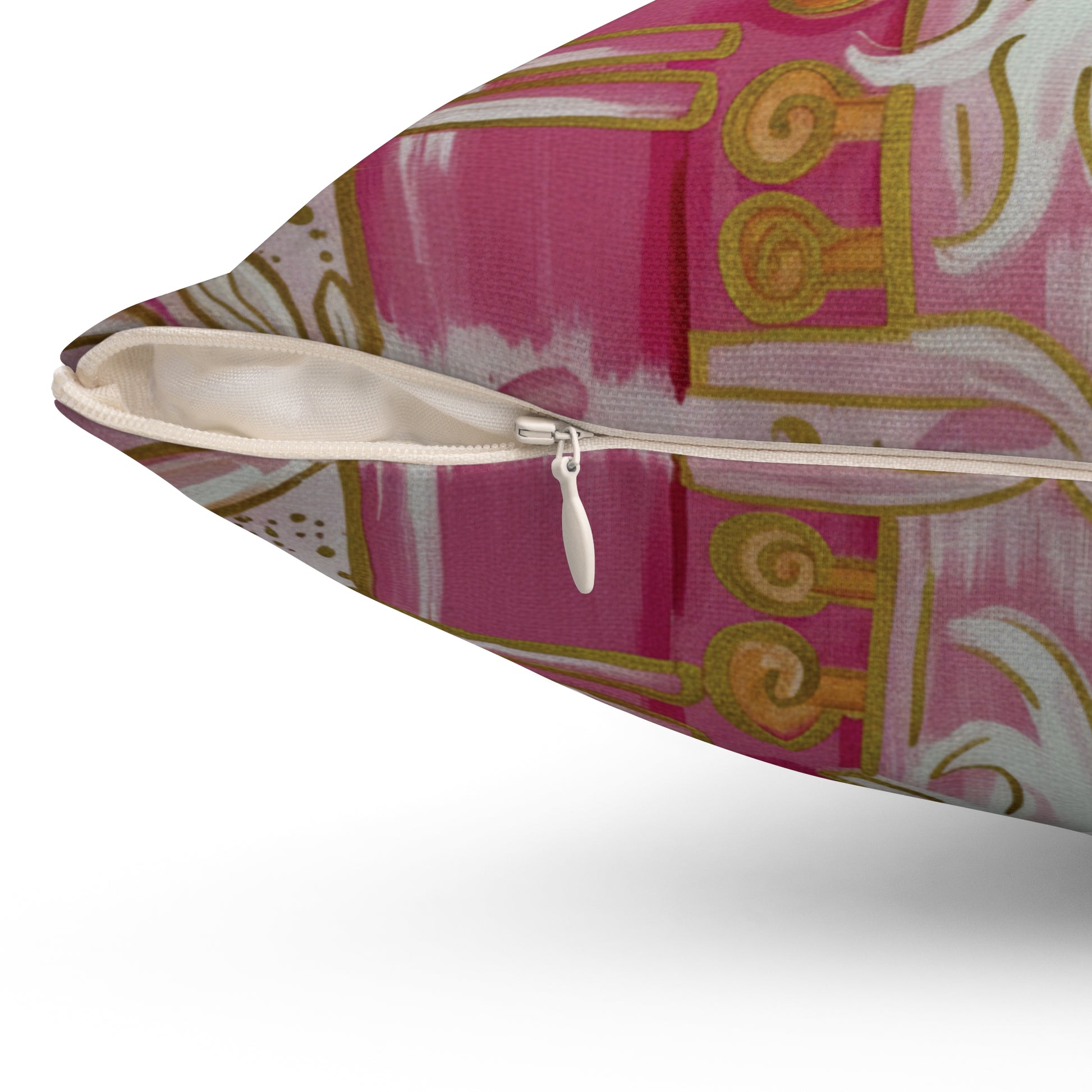 Decorative pillow with a pink and gold pattern on a white background
