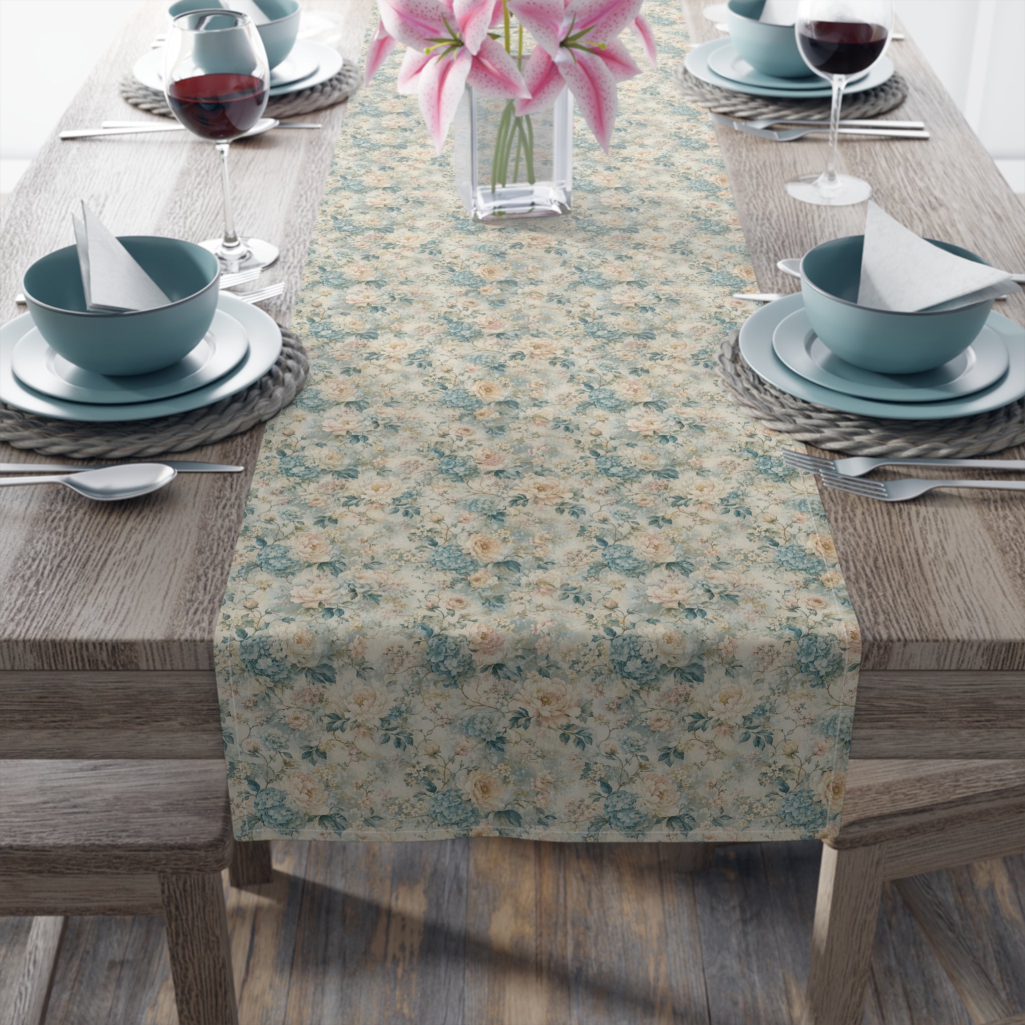 Dining table set with a patterned table runner, bowls, plates, and glasses.