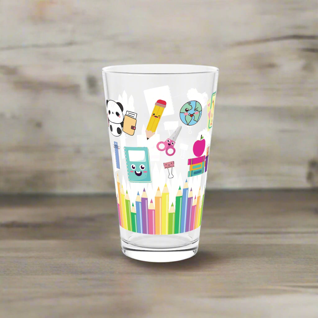 Clear glass with colorful stationery-themed design on a white background