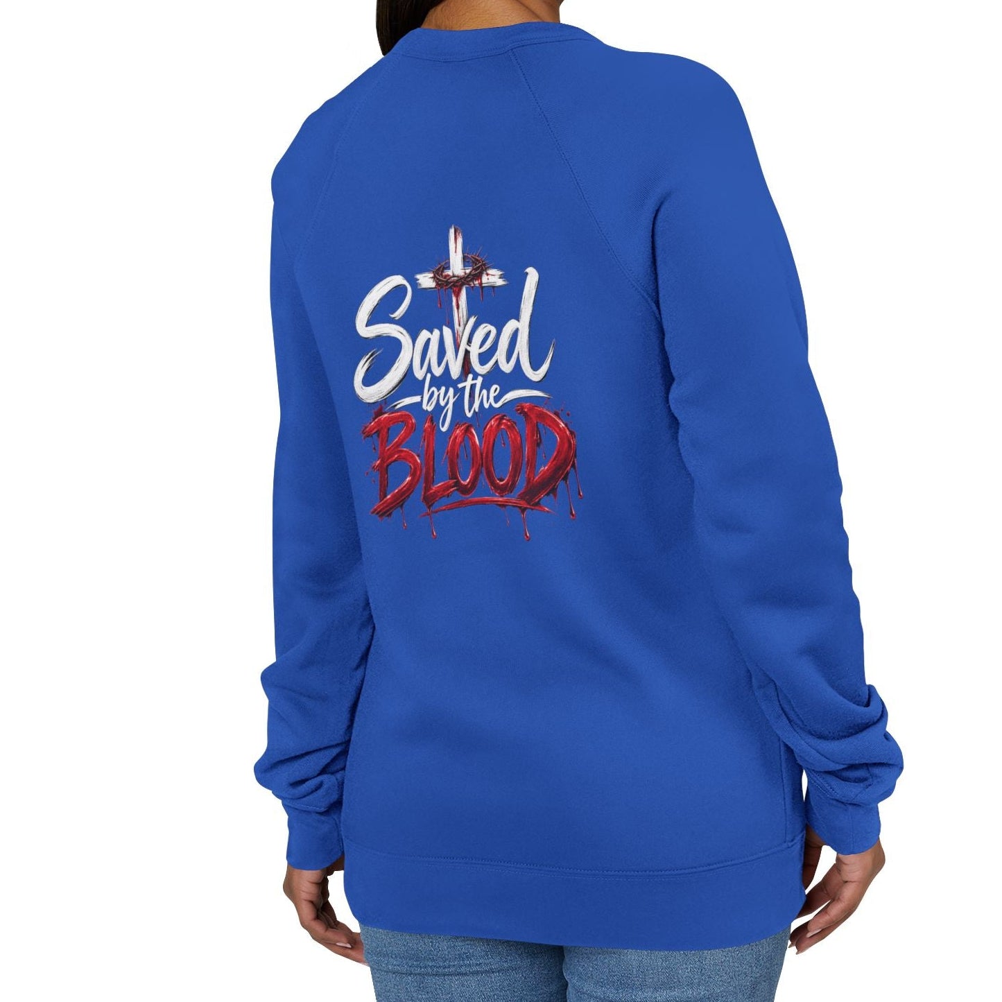 A woman shown from the back wearing a royal blue sweatshirt with a graphic on the back that reads 'Saved by the Blood' in white and red lettering with a cross above it, against a plain white background.
