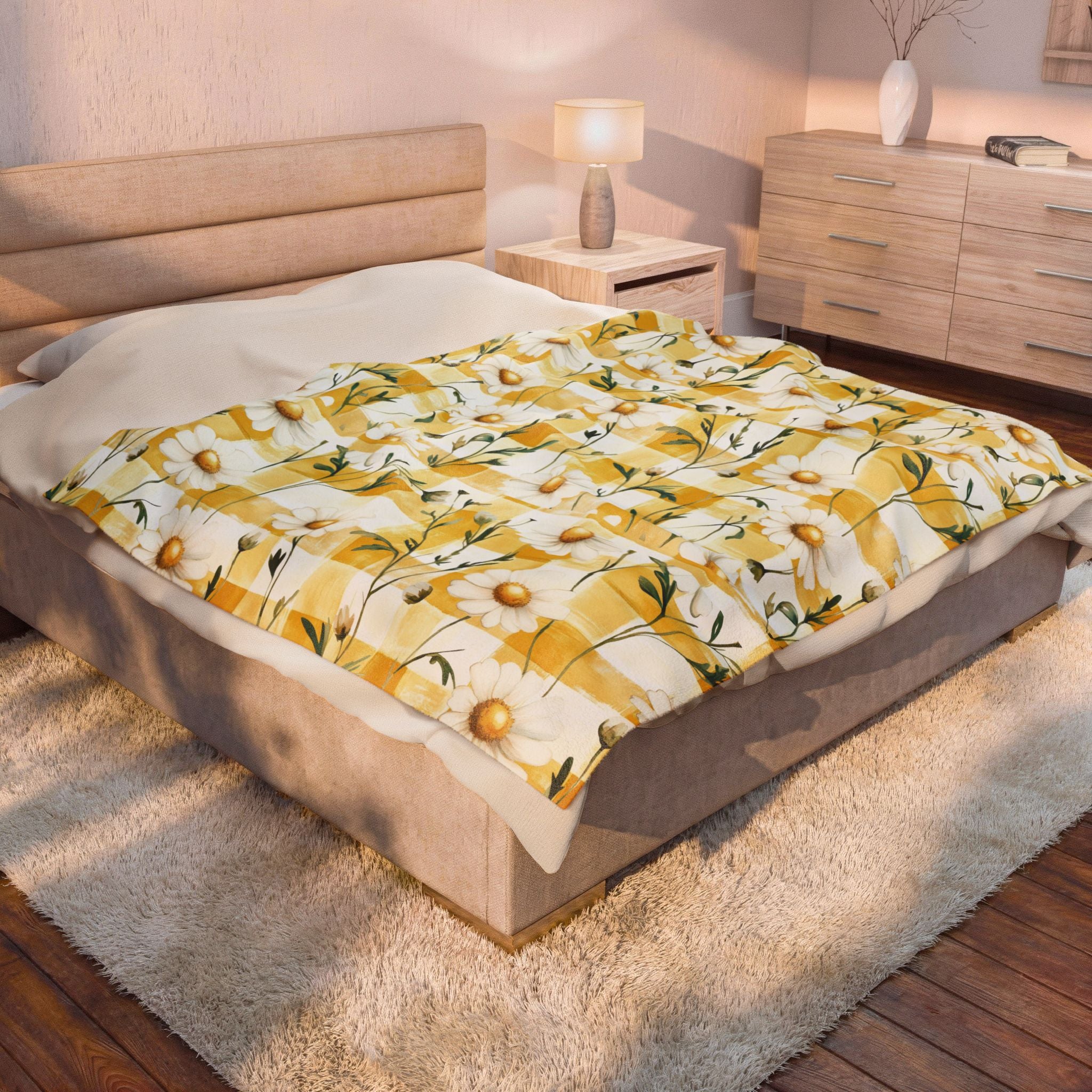 Bed with a yellow and white patterned comforter in a bedroom setting.